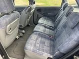 the interior of a car with blue seats and a steering wheel