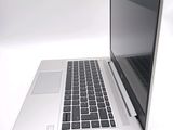 a silver laptop with a black keyboard on a white surface