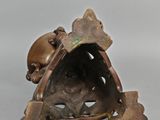 bronze figurine of a dog with a bone in its mouth