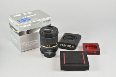 a camera lens, a flash drive, and a box of lenses