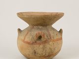 a brown vase with a design on it on a white surface