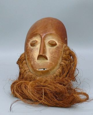 an image of a wooden mask with a long hair