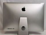 a silver apple computer sitting on top of a white table