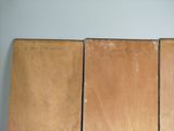 three pieces of wood sitting on top of a table next to each other