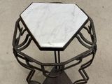 a white marble table with a metal frame on it