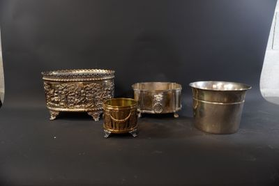 three silver cups and a silver cup on a black surface
