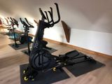several exercise bikes are lined up in a row in a gym