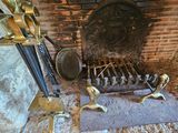 a fireplace with a fire place and a bunch of utensils on it
