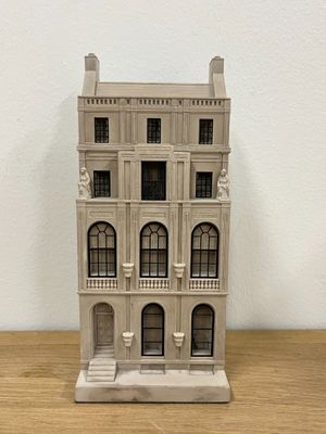 a small model of a building on a wooden table