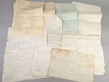 several old papers are stacked on top of each other on a table