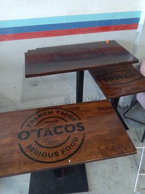 a table with two chairs and a table with a sign that says taco ' s