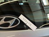 a car that has a sticker on the front window of it
