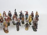 many figurines of people riding horses and horses