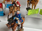 many figurines of soldiers on display in a glass case