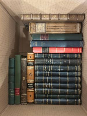 many books in a box that are stacked together