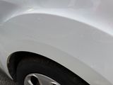 a close up of a car ' s front bumper and tire