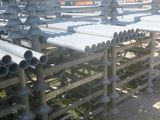 a lot of pipes that are stacked on the ground