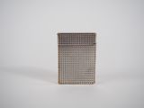 a close up of a metal object on a white surface