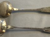 two spoons that are sitting next to each other