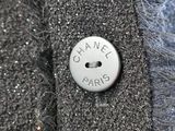 a button that says chanel paris on the back of a jacket