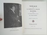 someone is holding a book with a picture of a man in a black coat