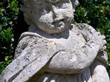 a statue of a boy holding a bird in his arms