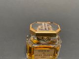 an image of a bottle of perfume sitting on a table