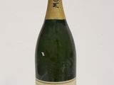 a close up of a bottle of champagne on a white surface