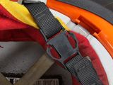 a close up of a helmet with a red and yellow strap