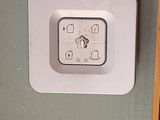 a white clock mounted to the side of a green wall