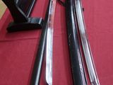two swords on a table with a red table cloth