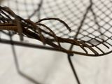 a wire chair that has been placed on a table
