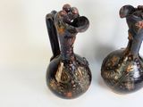 two vases that are sitting on a white surface