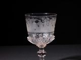 a glass cup that is sitting on a table