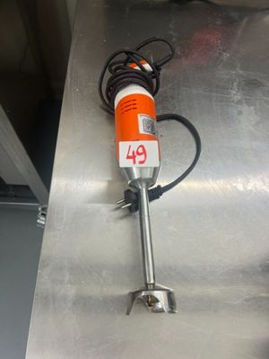 an orange and white electric hand held device on a metal surface