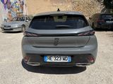 the rear end of a grey car parked in a parking lot