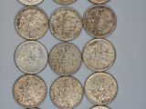 a close up of a bunch of silver coins on a table