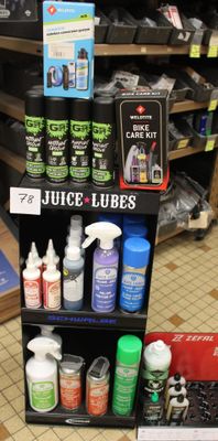 bottles of juice and other cleaning products are on display in a store
