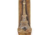 gold plated eiffel tower bottle opener with a black eye