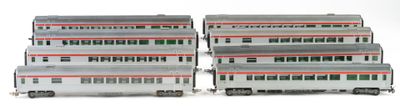 three model trains are stacked on top of each other on a white surface