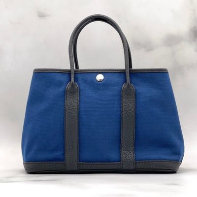 a blue and black tote bag on a white background