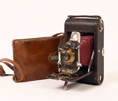 un étui en cuir marron contenant un appareil photo et un sac marron