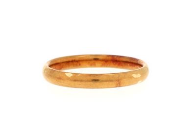 a close up of a gold ring on a white background