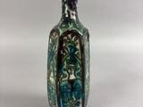 a small glass bottle with a design on it