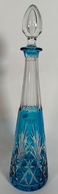 a blue glass decanter with a clear top
