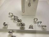 a display of silver jewelry on display in a glass case