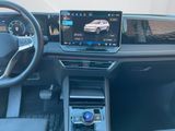 the interior of a car with a touch screen and a steering wheel