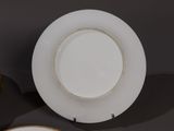 a white plate with a gold rim and a white plate with a gold rim