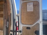 a white van that has a door open and some wood in it
