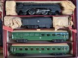 three train cars in a red case on a table